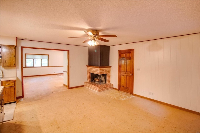 unfurnished living room featuring a textured ceiling, light carpet, ceiling fan, and a brick fireplace