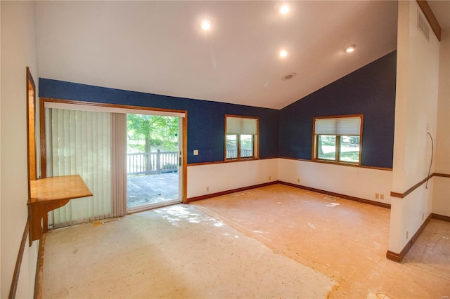 unfurnished room with lofted ceiling