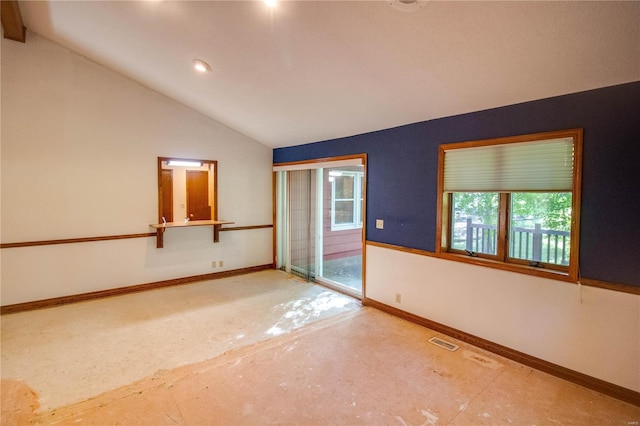 spare room featuring vaulted ceiling