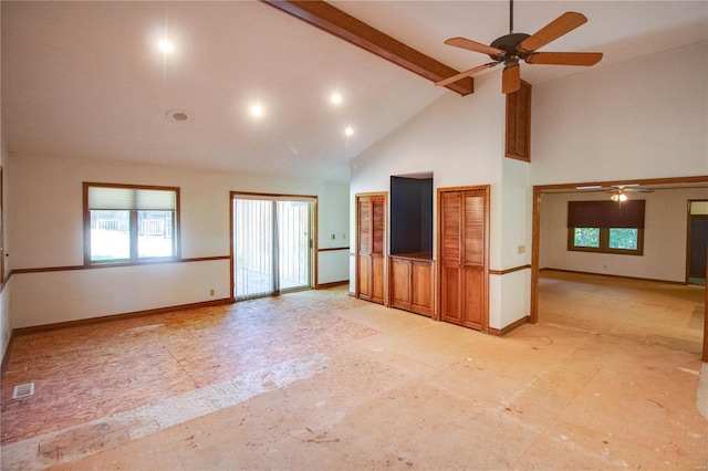 unfurnished living room with high vaulted ceiling, ceiling fan, and beamed ceiling