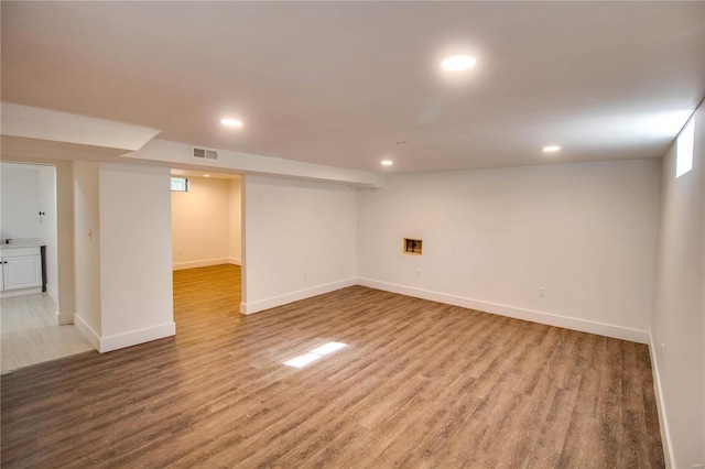 basement featuring hardwood / wood-style flooring