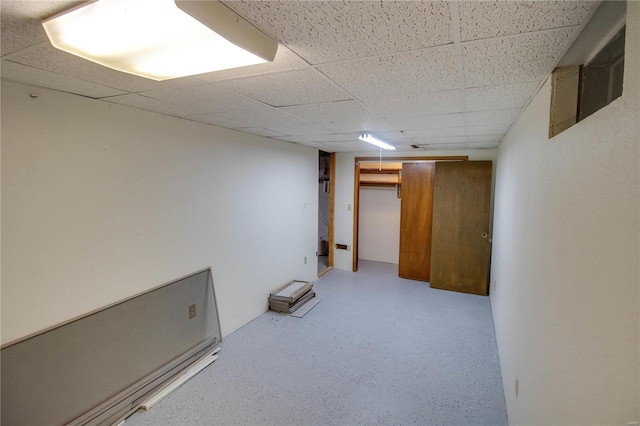 basement featuring a drop ceiling