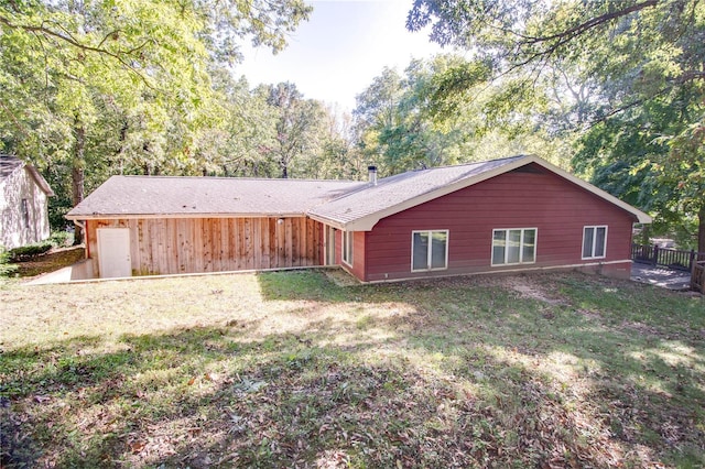 rear view of house with a yard