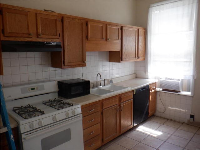 kitchen with light tile patterned floors, extractor fan, cooling unit, black appliances, and sink