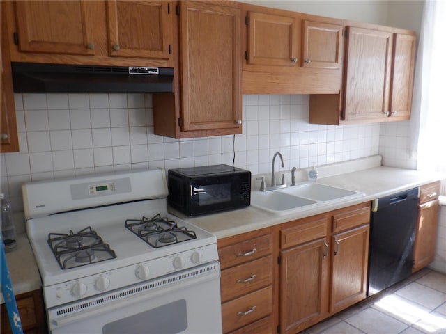 kitchen with decorative backsplash, light tile patterned flooring, black appliances, sink, and ventilation hood