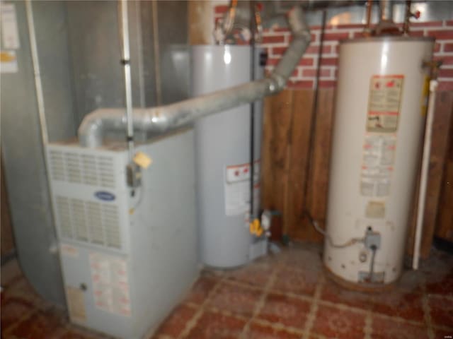 utility room with heating unit and gas water heater