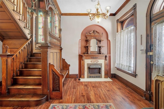 interior space with crown molding, radiator heating unit, a chandelier, and hardwood / wood-style flooring