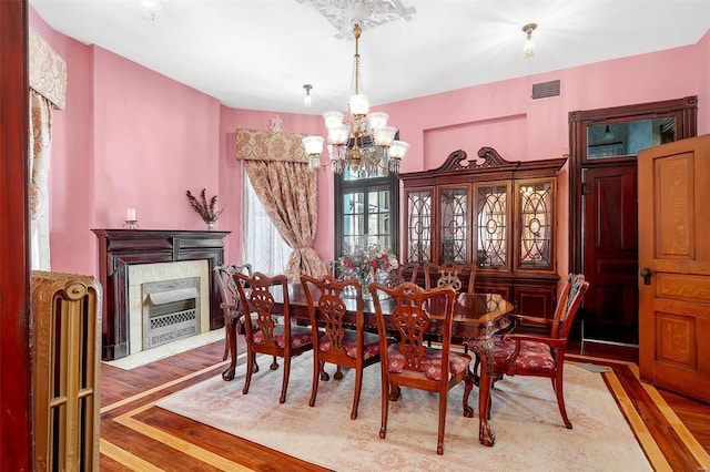 dining room with a chandelier and hardwood / wood-style flooring