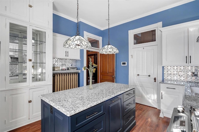 kitchen with a center island, backsplash, blue cabinets, hanging light fixtures, and white cabinetry