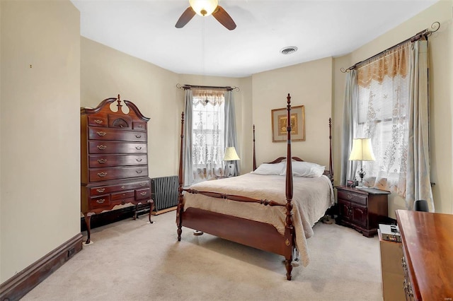 carpeted bedroom featuring ceiling fan and radiator