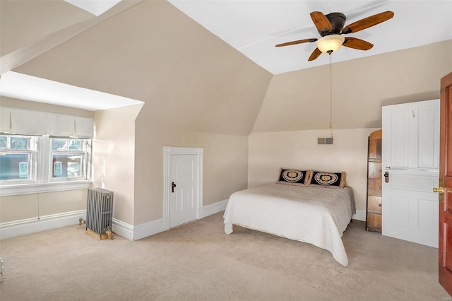 bedroom featuring radiator, ceiling fan, light colored carpet, and vaulted ceiling