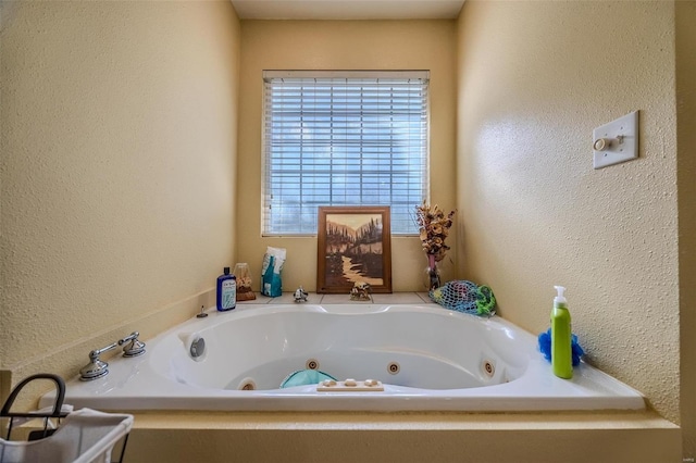 bathroom with plenty of natural light and a washtub