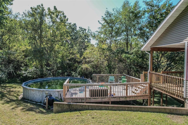 view of pool featuring a wooden deck and a lawn