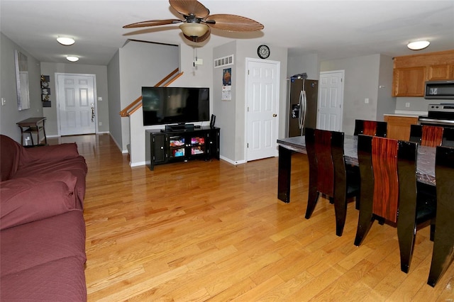 dining space with light hardwood / wood-style floors and ceiling fan