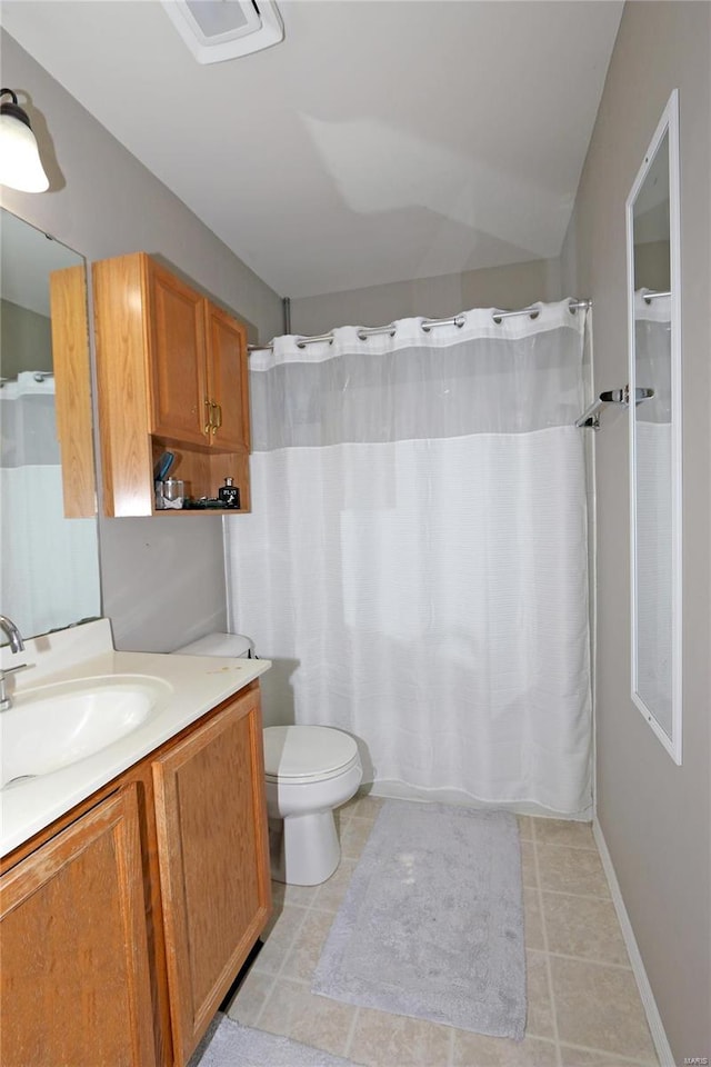 bathroom featuring tile patterned floors, a shower with curtain, vanity, and toilet