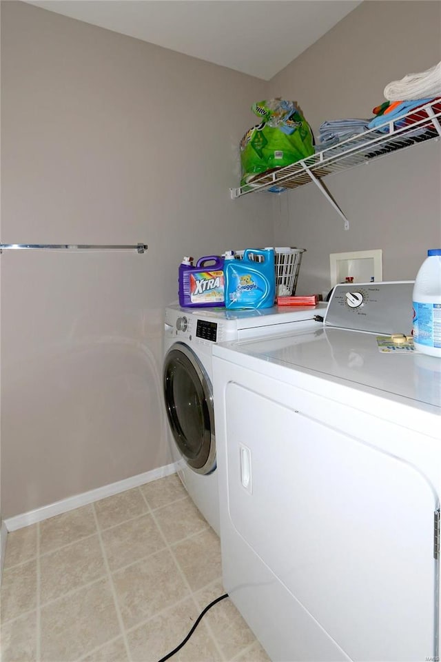 clothes washing area with washer and clothes dryer