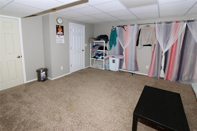 basement with carpet floors and a paneled ceiling