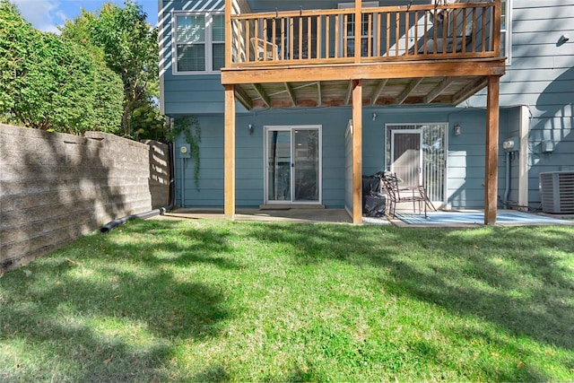 rear view of house with a yard, a patio area, and central AC unit