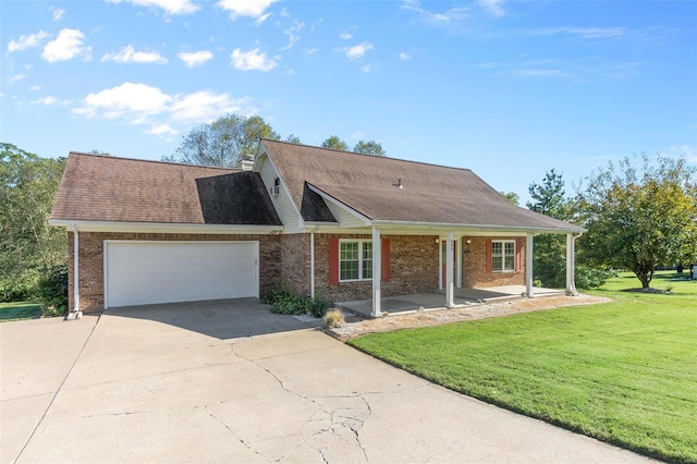 view of front of home featuring covered porch, a front yard, and a garage