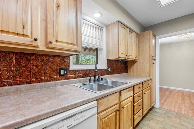 kitchen featuring backsplash, light brown cabinets, white dishwasher, light hardwood / wood-style flooring, and sink