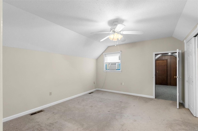 bonus room with cooling unit, vaulted ceiling, ceiling fan, and light carpet