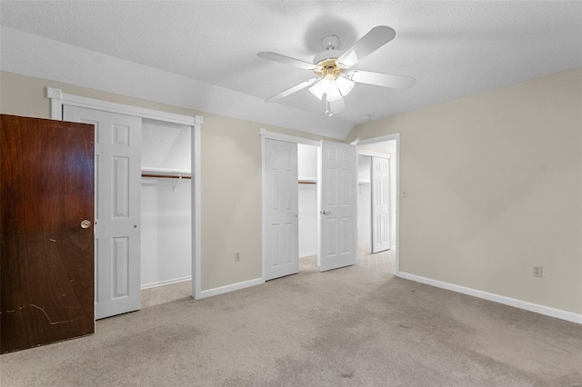 unfurnished bedroom with a textured ceiling, light carpet, and ceiling fan