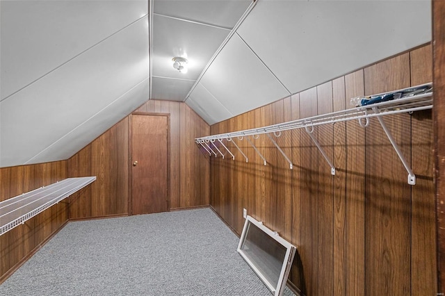 spacious closet featuring light colored carpet and lofted ceiling