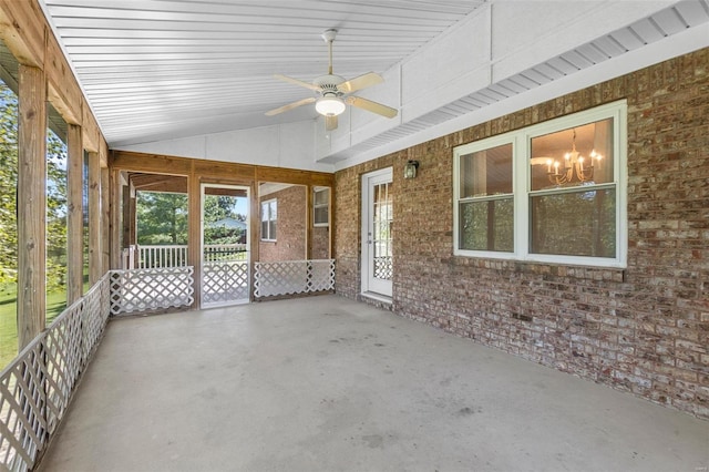 unfurnished sunroom featuring ceiling fan with notable chandelier and lofted ceiling