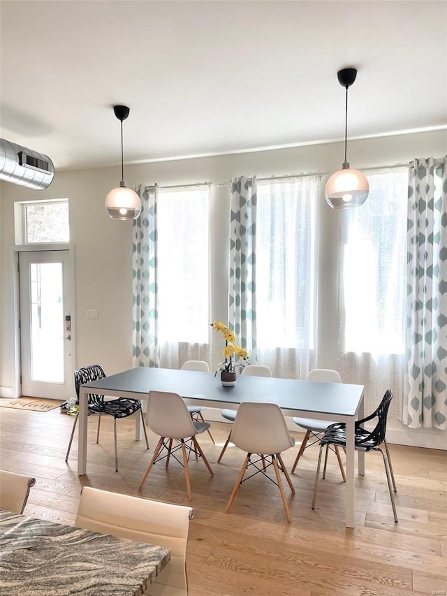 dining area with light hardwood / wood-style flooring and plenty of natural light