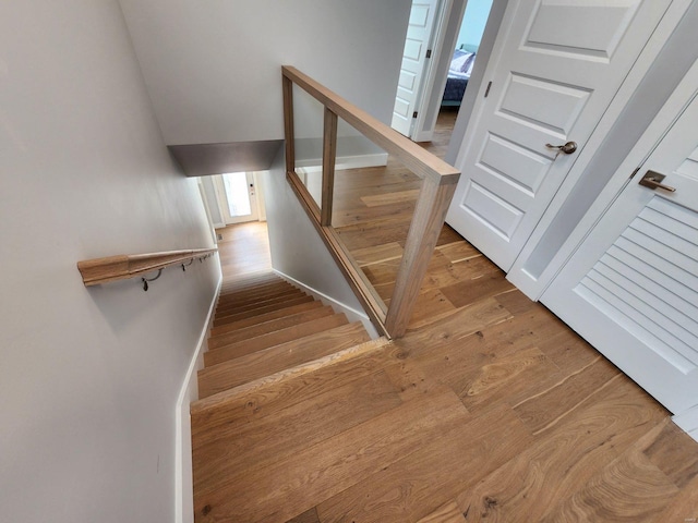 stairs featuring wood-type flooring