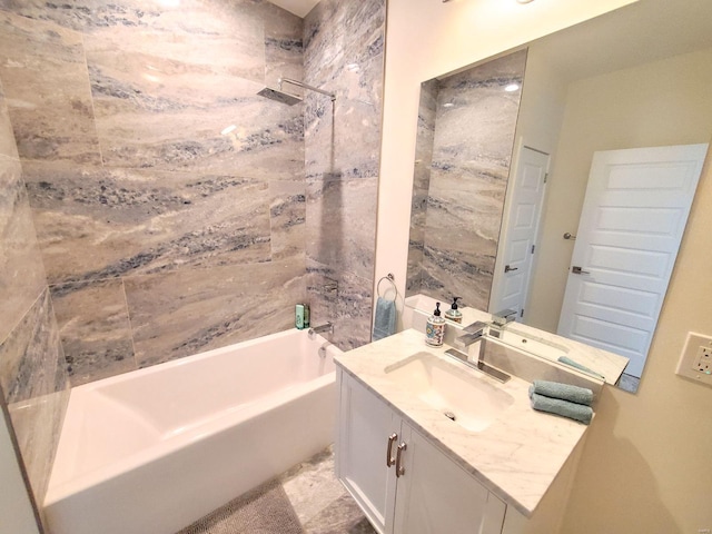 bathroom with vanity and tiled shower / bath combo