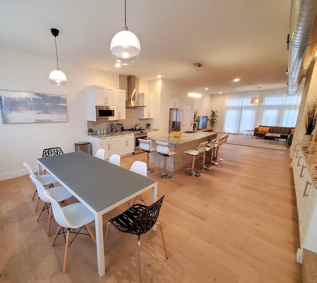 dining space featuring light hardwood / wood-style floors