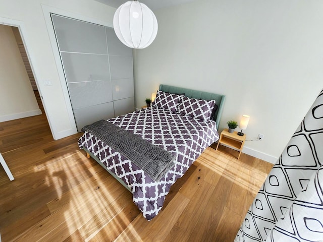 bedroom with wood-type flooring