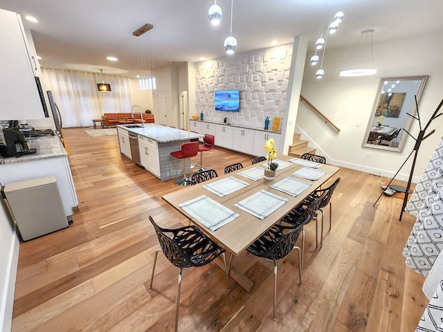 dining space featuring light hardwood / wood-style flooring and sink