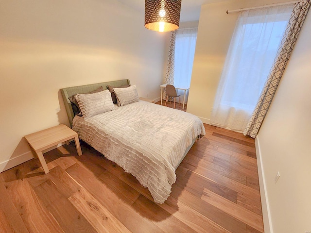 bedroom with wood-type flooring