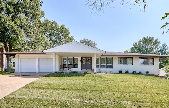 ranch-style home with a front lawn, covered porch, and a garage