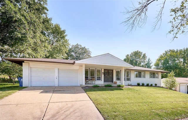 single story home with covered porch, a garage, and a front lawn