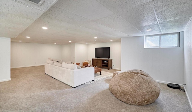 carpeted living room featuring a paneled ceiling