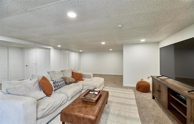 carpeted living room featuring a paneled ceiling