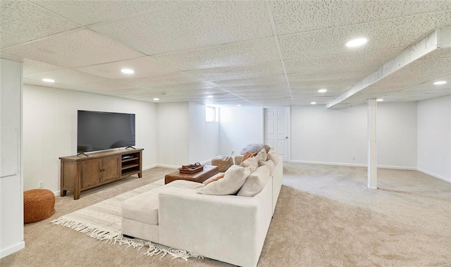 living room featuring light colored carpet and a drop ceiling