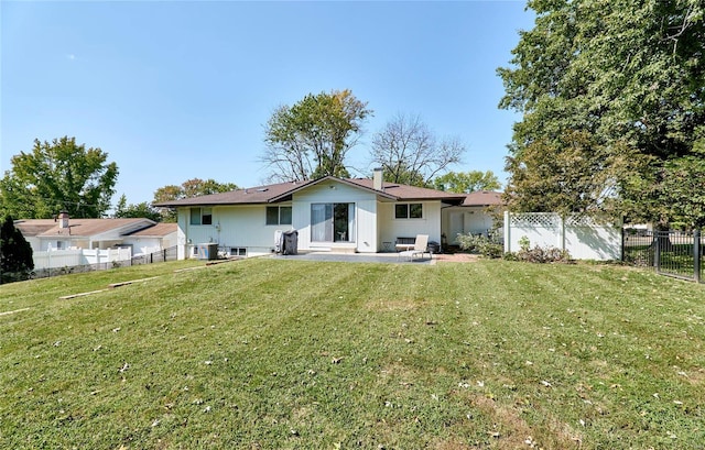 back of house with cooling unit, a patio area, and a lawn