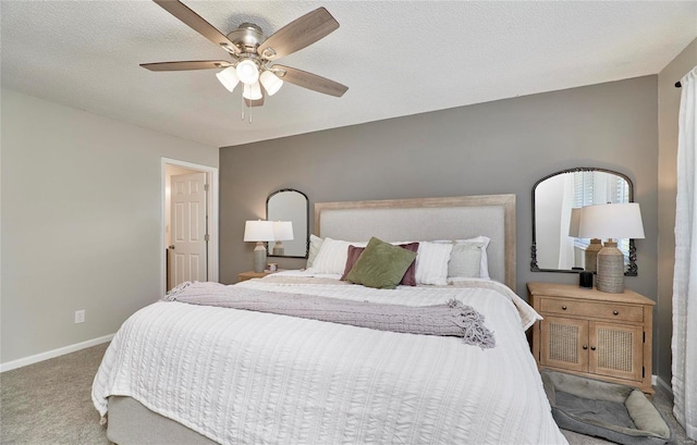 bedroom featuring carpet flooring, ceiling fan, and a textured ceiling