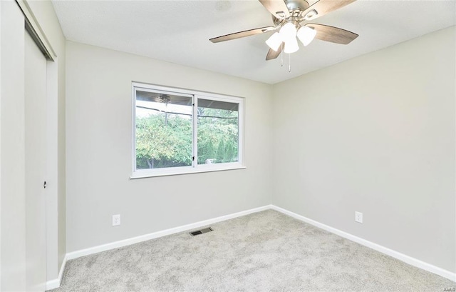 carpeted empty room with ceiling fan