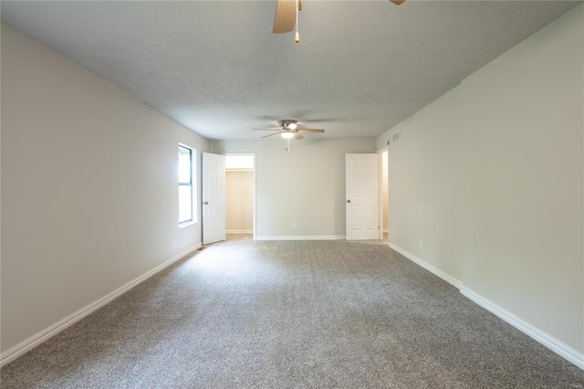 spare room featuring carpet, a textured ceiling, and ceiling fan