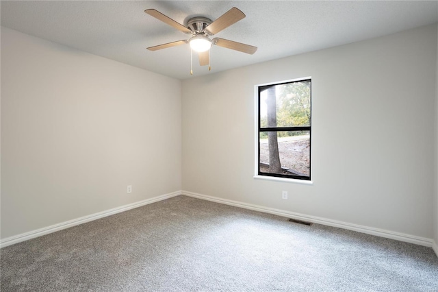 spare room featuring ceiling fan and carpet flooring