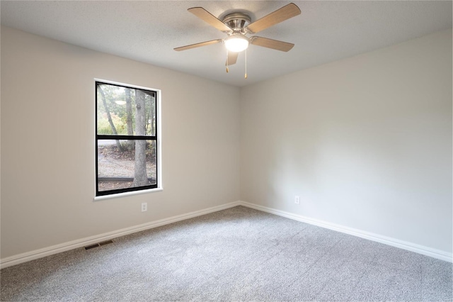 spare room with ceiling fan and carpet flooring