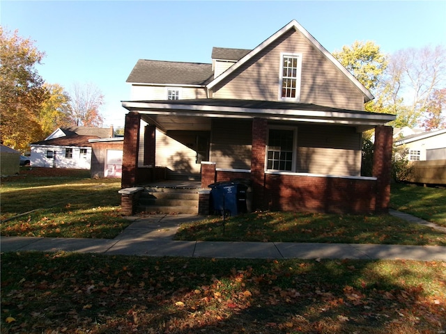 view of front of home with covered porch and a front lawn