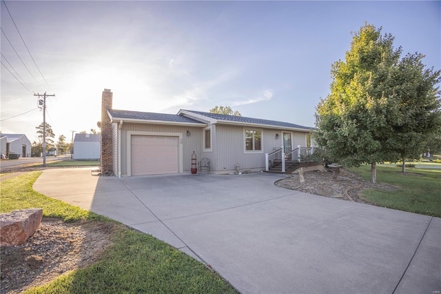 ranch-style house featuring a front yard and a garage