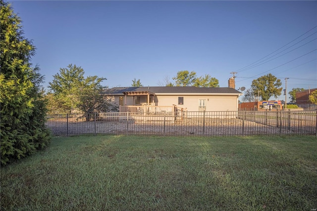 rear view of property featuring a lawn