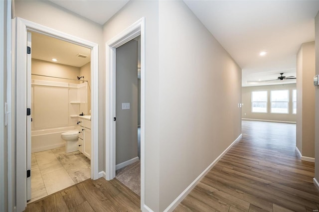 hall with light hardwood / wood-style flooring